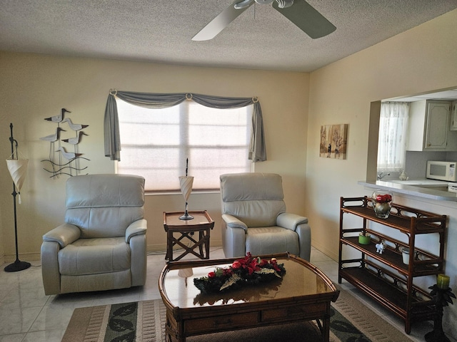 living room with light tile patterned floors and a textured ceiling