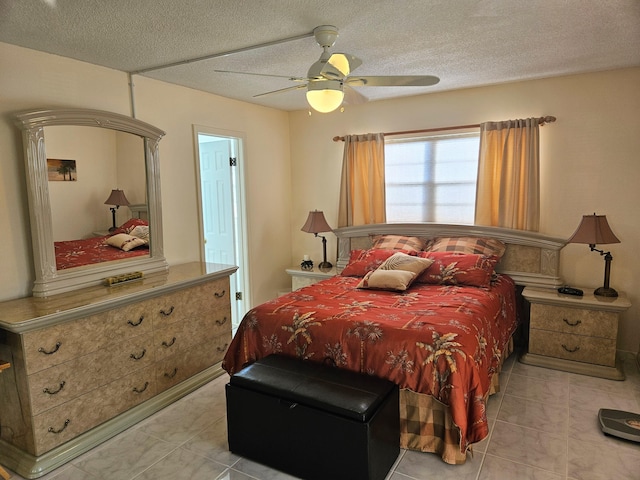 tiled bedroom with a textured ceiling and ceiling fan