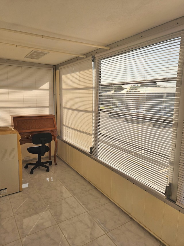 unfurnished office featuring light tile patterned flooring