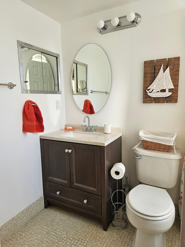 bathroom featuring tile patterned flooring, vanity, and toilet