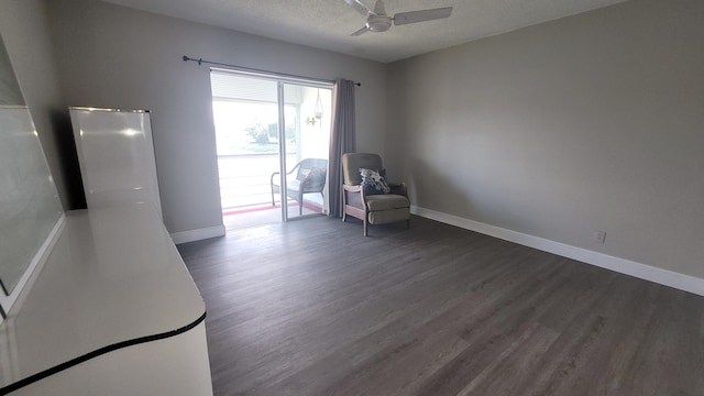 unfurnished room with a textured ceiling, dark hardwood / wood-style flooring, and ceiling fan