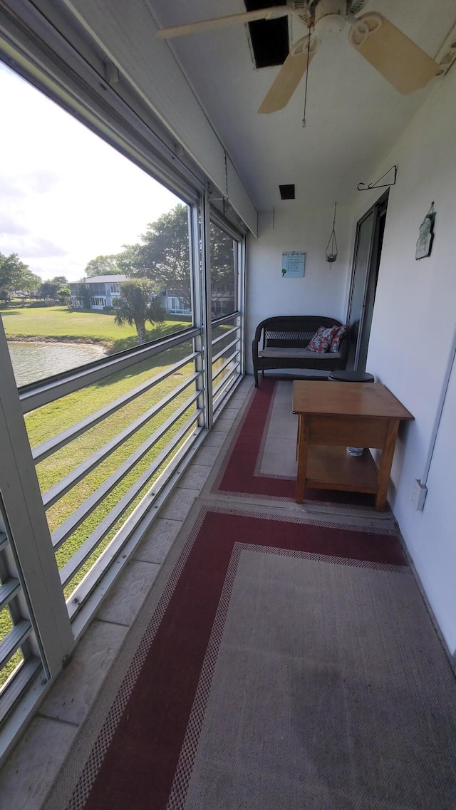 unfurnished sunroom with ceiling fan and a wealth of natural light