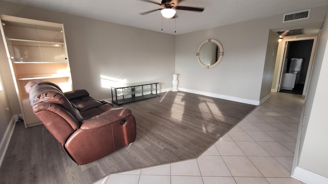 living room with ceiling fan and light hardwood / wood-style flooring