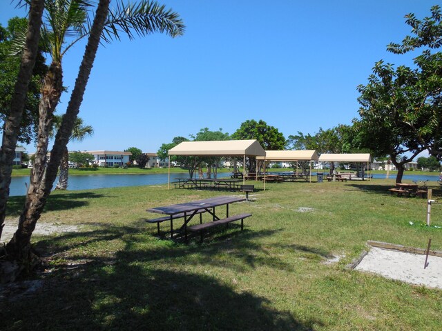 view of community with a lawn and a water view