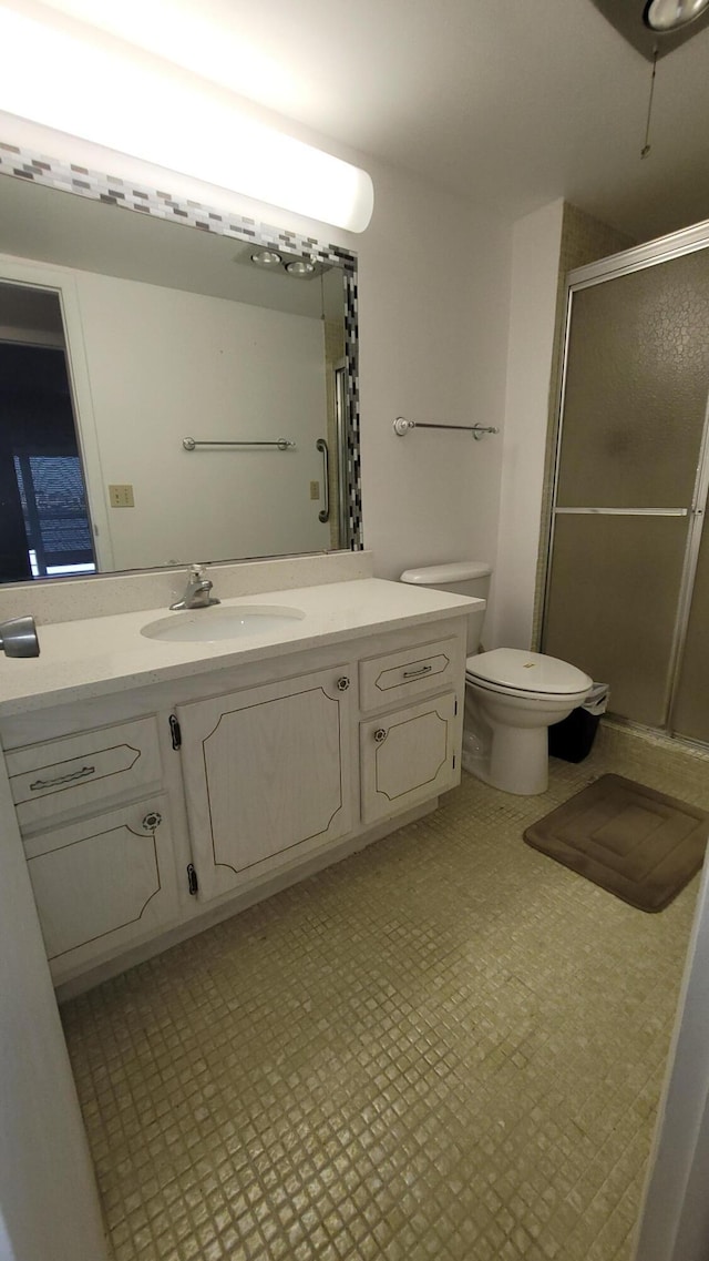 bathroom with vanity, toilet, and walk in shower