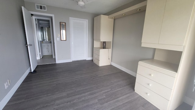 unfurnished bedroom featuring dark wood-type flooring