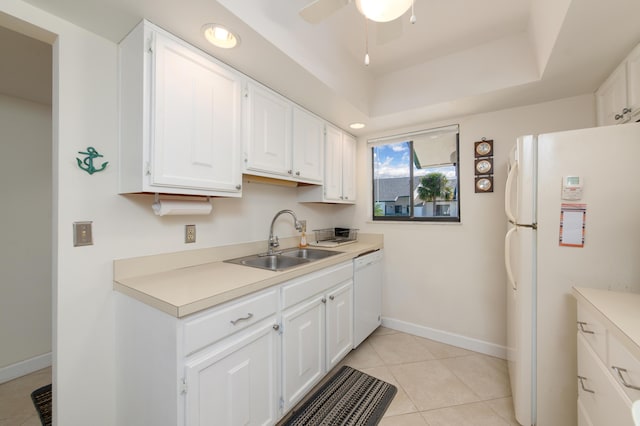 2400 S Ocean Dr Unit 6523, Fort Pierce, FL 34949 - kitchen with a tray ceiling, light tile patterned flooring, white appliances, white cabinetry, and a sink