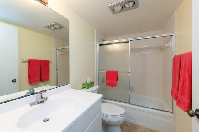 full bathroom featuring toilet, combined bath / shower with glass door, tile patterned flooring, and vanity