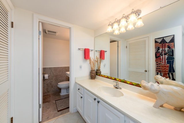 2400 S Ocean Dr Unit 6523, Fort Pierce, FL 34949 - bathroom featuring vanity, visible vents, tile patterned floors, toilet, and tile walls