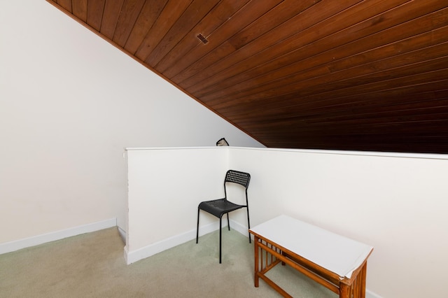 living area featuring light carpet, vaulted ceiling, and wooden ceiling