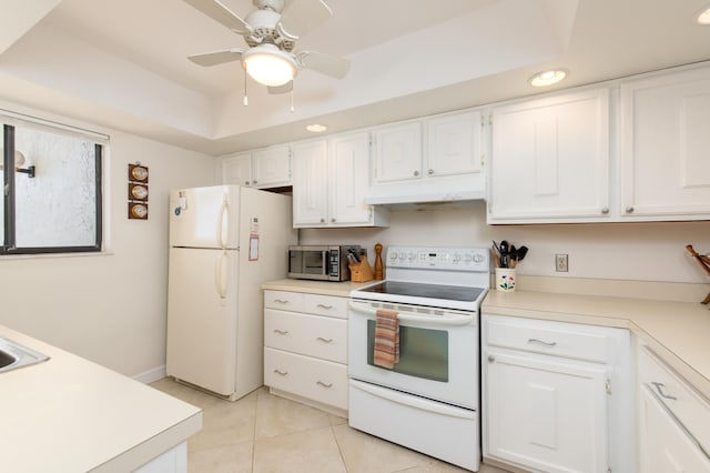 kitchen with white cabinetry, ceiling fan, a tray ceiling, white appliances, and light tile patterned flooring