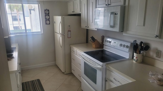 kitchen featuring white cabinetry, white appliances, and light tile patterned floors