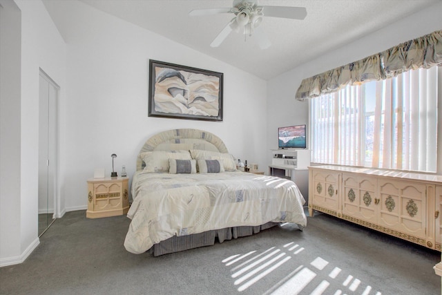 carpeted bedroom featuring vaulted ceiling and ceiling fan