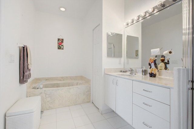 bathroom with tile patterned flooring, vanity, and a washtub