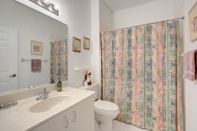 bathroom with tile patterned flooring, vanity, and toilet