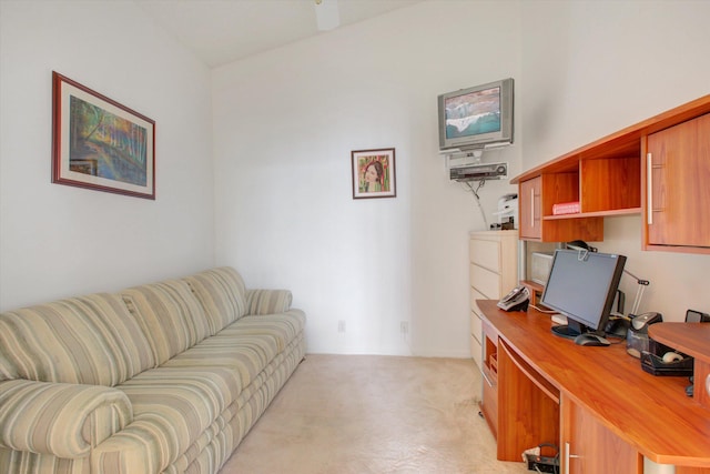 carpeted home office with vaulted ceiling