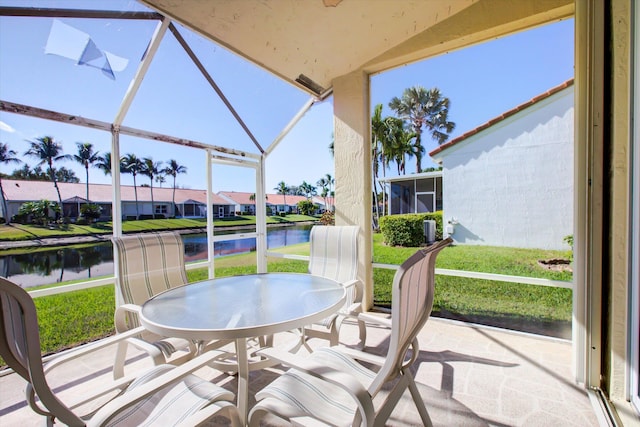 sunroom / solarium featuring a water view