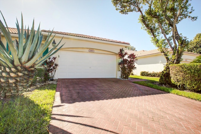 mediterranean / spanish-style home with a garage