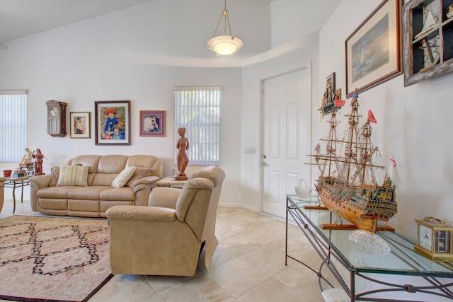 living room with light tile patterned floors and lofted ceiling