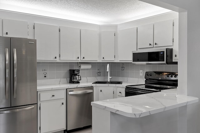 kitchen featuring white cabinets, backsplash, sink, and stainless steel appliances