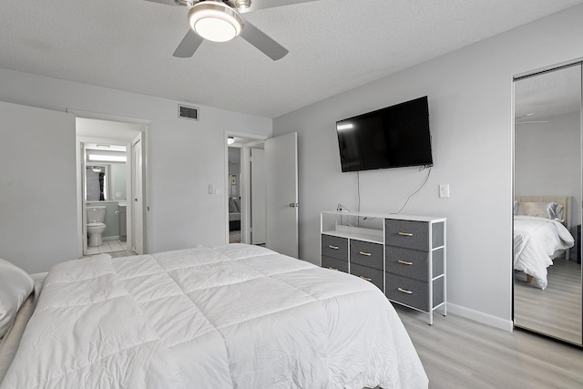 bedroom with a closet, ceiling fan, light hardwood / wood-style flooring, and a textured ceiling