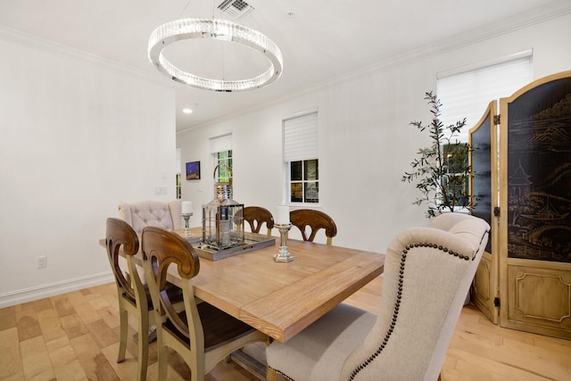 dining room with crown molding, light hardwood / wood-style flooring, and a notable chandelier