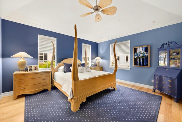 bedroom with ceiling fan, ornamental molding, and light hardwood / wood-style flooring