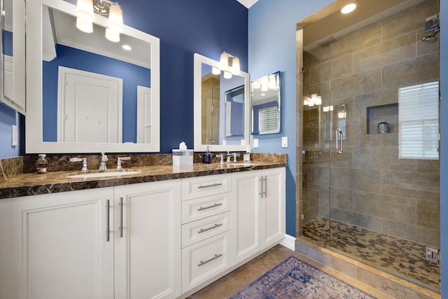 bathroom featuring tile patterned flooring, vanity, and an enclosed shower