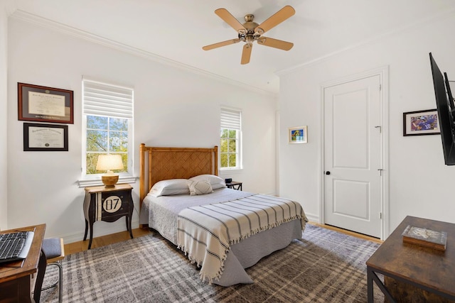 bedroom with ceiling fan, wood-type flooring, and ornamental molding