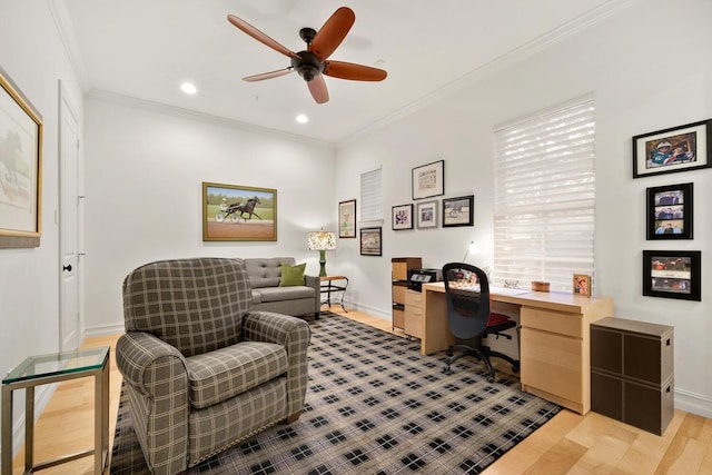 home office featuring light wood-type flooring, ceiling fan, and ornamental molding