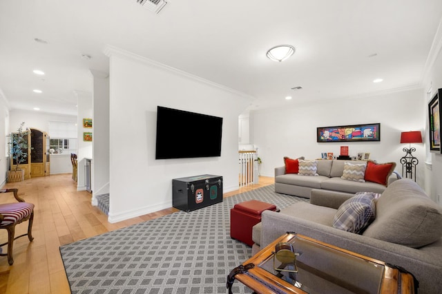 living room with ornamental molding and light wood-type flooring