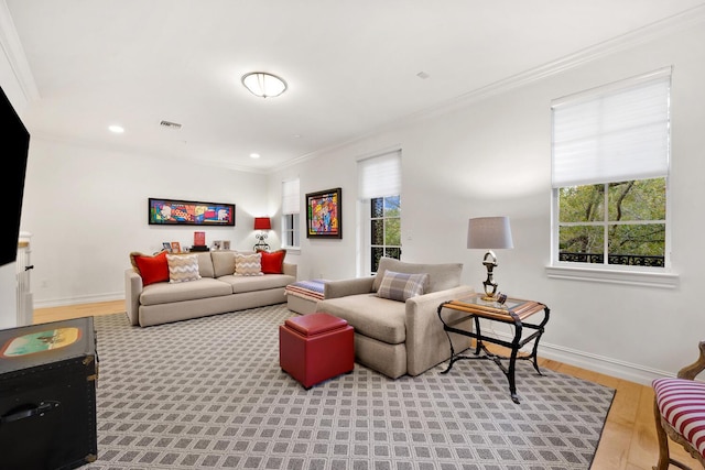 living room with light hardwood / wood-style floors and ornamental molding