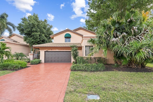 mediterranean / spanish-style home with a garage and a front lawn