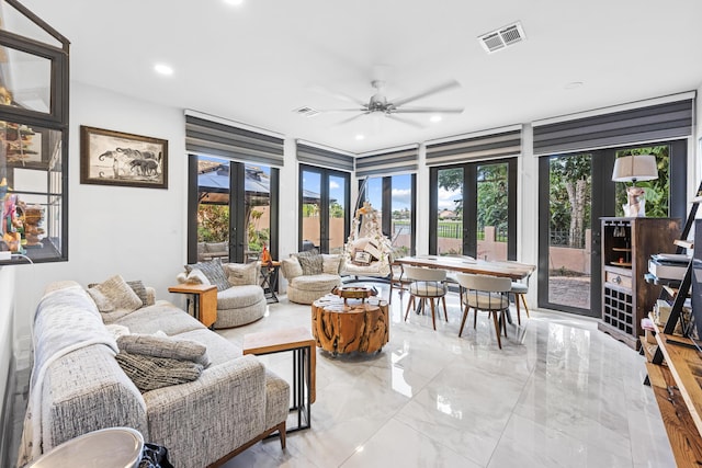 living room with ceiling fan and french doors