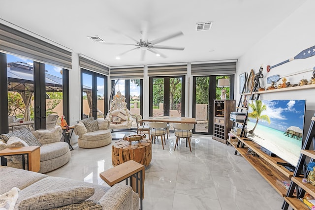 sunroom / solarium with ceiling fan and french doors