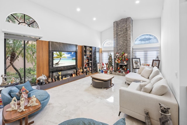 living room featuring a fireplace and high vaulted ceiling