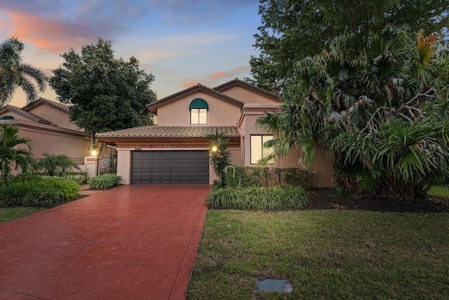 mediterranean / spanish house featuring a lawn