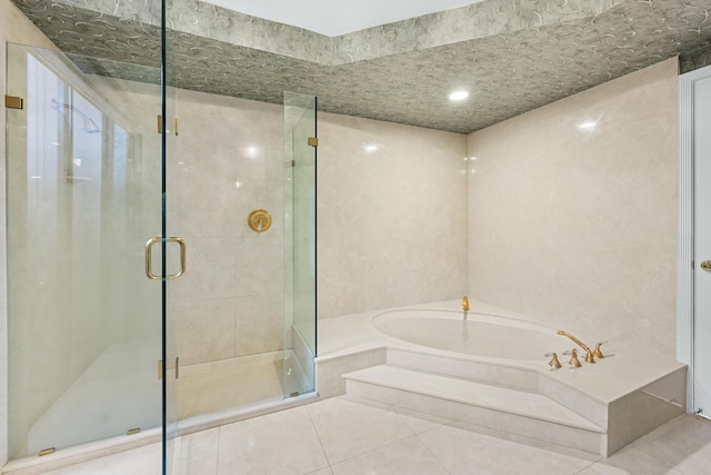 bathroom featuring tile patterned floors and separate shower and tub