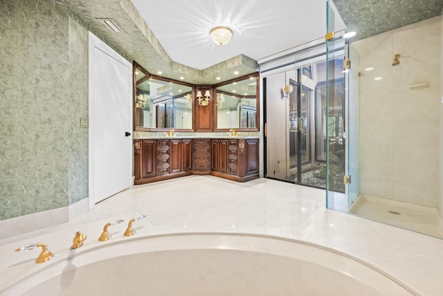 bathroom with vanity and shower with separate bathtub