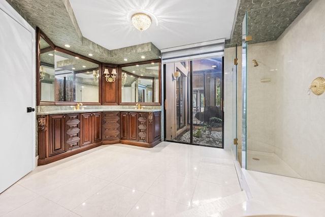 bathroom featuring tile patterned flooring, vanity, and walk in shower