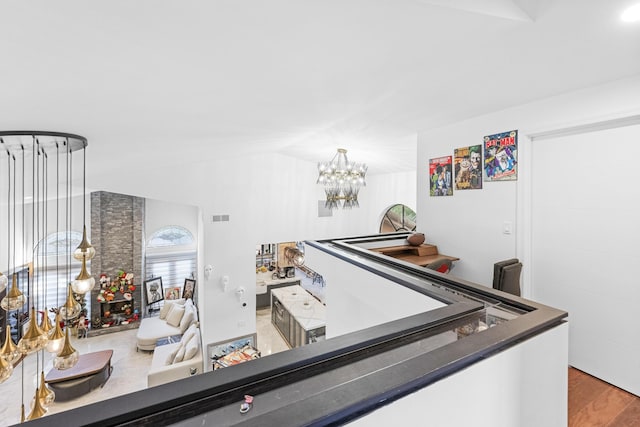 interior space featuring wood-type flooring and an inviting chandelier