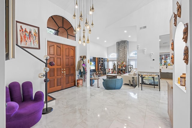 entrance foyer featuring high vaulted ceiling