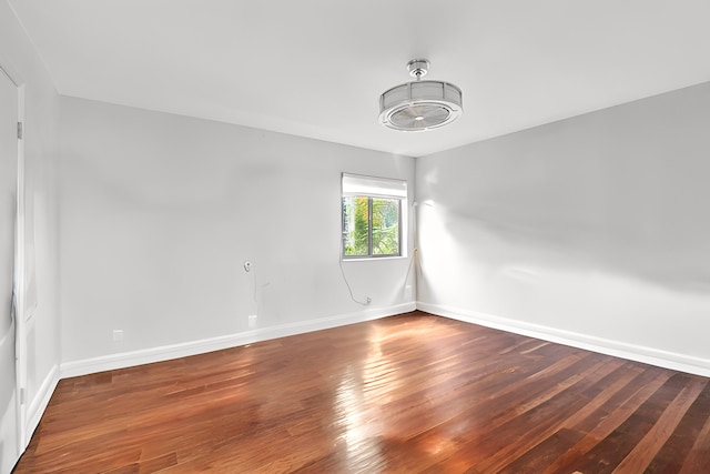 unfurnished room featuring dark hardwood / wood-style flooring