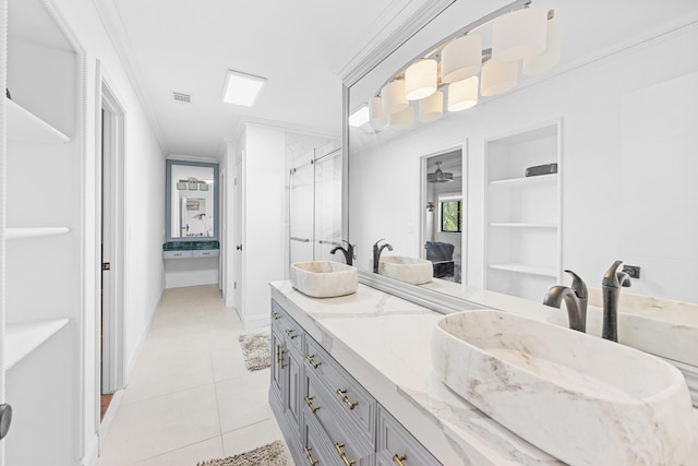 bathroom with vanity, tile patterned floors, an enclosed shower, and crown molding