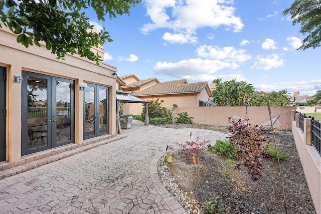 view of yard featuring a patio area and french doors