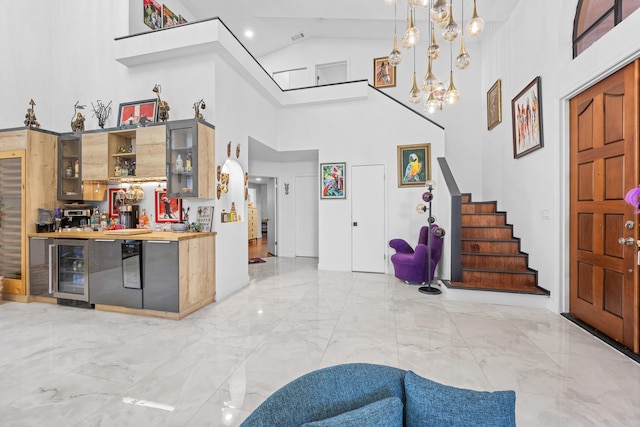 entryway with wine cooler and high vaulted ceiling