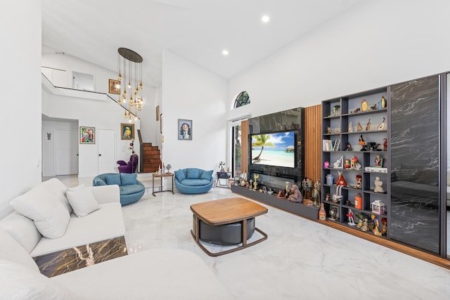 living room featuring an inviting chandelier and high vaulted ceiling