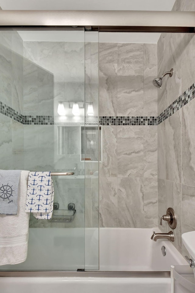 bathroom featuring toilet and enclosed tub / shower combo