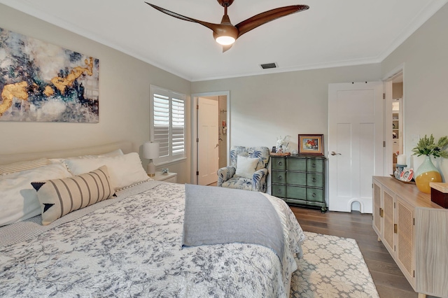 bedroom featuring ceiling fan, crown molding, and dark wood-type flooring