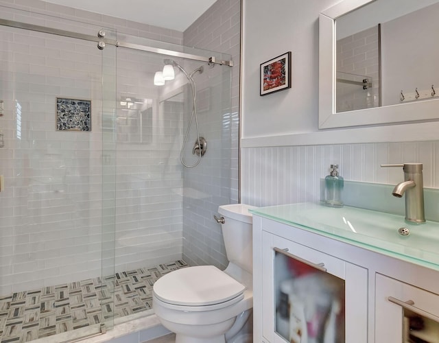 bathroom featuring an enclosed shower, vanity, and toilet